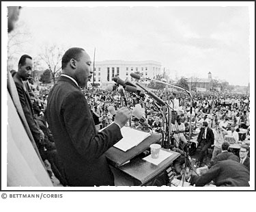 Dr. Martin Luther King, Jr. speaks in front of the Alabama State Capitol to an estimated 30,000 demonstrators who followed him on the last leg of the Selma-Mongomery Civil Rights Marches on March 25, 1965.