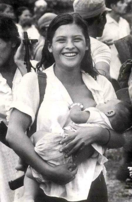 Armed Sandtinista Rebel breastfeeding (Nicarargua, 1984)