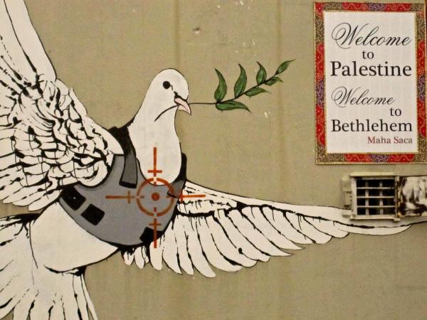 Armoured dove with olive branch by Banksy. 