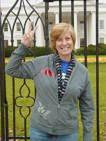 Cindy Sheehan gives the peace sign in front of the White House in 2006.