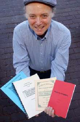 Composer Roger Lee Hall holding some of his music publications