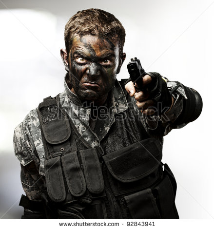 stock-photo-portrait-of-angry-young-soldier-aiming-with-gun-against-a-abstract-lights-background-92843941