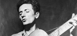 woody-guthrie-playing-guitar-631 0