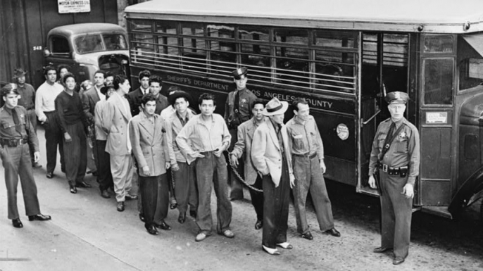 Zoot suiters lined up outside Los Angeles jail en route to court after feud with sailors, 1943. (Credit: The Library of Congress)