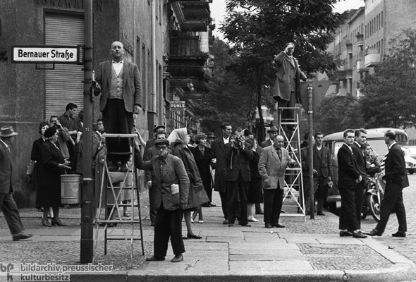 Berlino, Bernauer Straße, 13 agosto 1961. La strada sta per essere divisa in due. I berlinesi della parte occidentale assistono alla costruzione del Muro.