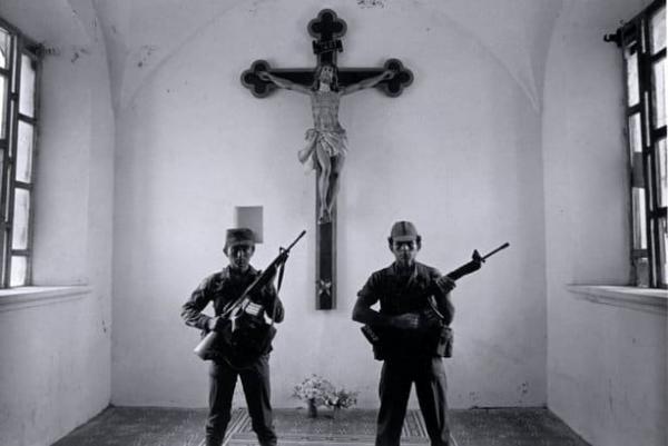  Suchitoto-Government soldiers in a church in an area very near the Guazapa Mountain guerrilla stronghold. The Catholic Church suffered persecution because it spread Liberation Theology, 1986 credit to Larry Towell: Magnum Photos 