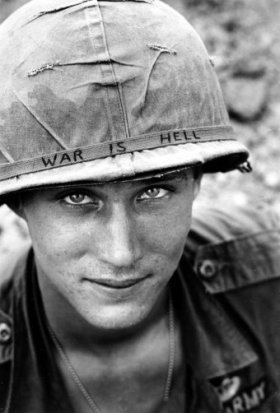 An unidentified U.S. Army soldier wears a hand lettered "War Is Hell" slogan on his helmet, in Vietnam on June 18, 1965. (AP Photo/Horst Faas, File) 