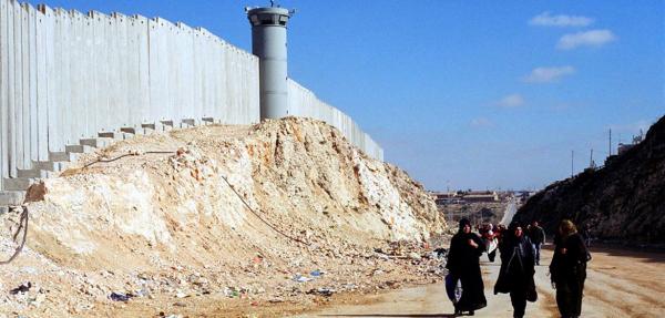  Palestinian women walk by Israel's barrier credit: Shabtai Gold