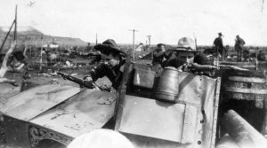 National Guard posing in destroyed camp colony.